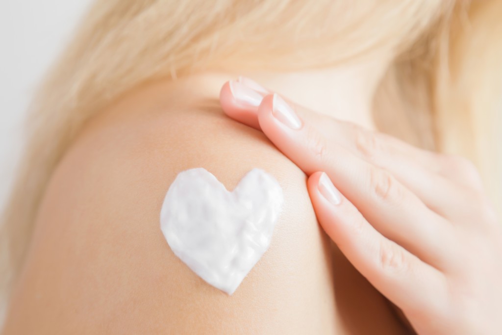 lotion-shaped-heart on a woman's shoulder