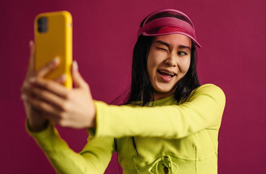 Woman in Colorful Outfit Taking Selfie